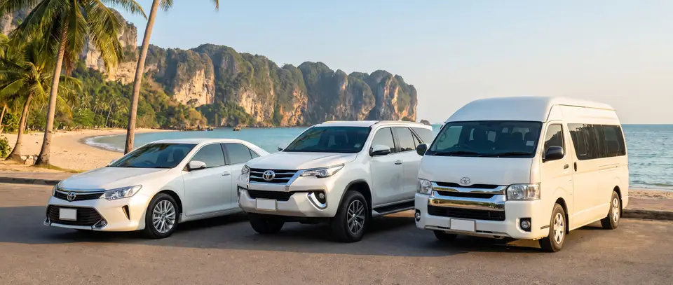 Sedan, SUV and van parked on the Ao Nang beach road